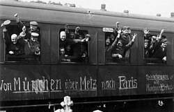 German soldiers in a railway car on the way to the front in August 1914. The message on the car reads Von München über Metz nach Paris. (From Munich via Metz to Paris).