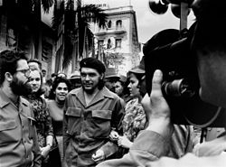 Guevara in 1960, walking through the streets of Havana with his second wife Aleida March (right)