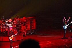 Rush live in concert with rotisseries and chef in background