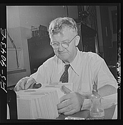 Tommy Bracken, head of the archive, working in 1942