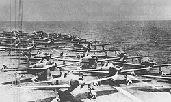 Mitsubishi A6M Zero fighter aircraft and other aircraft preparing for takeoff on the aircraft carrier Shōkaku on 7 December 1941, for the attack on Pearl Harbor