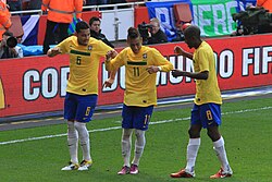 Neymar celebrates his goal for Brazil against Scotland, on 27 March 2011, with André Santos and Ramires.