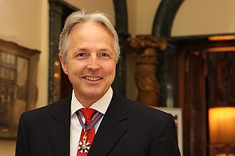 Christopher Prentice wearing the insignia of a Companion of the Order of Saint Michael and St George