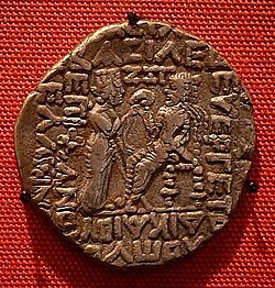 Silver Tetradrachm of Vologases I Enthroned king Vologases I facing left, receiving diadem from Tyche, standing with sceptre. AD 55-56