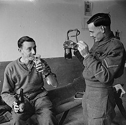 A British soldier enjoying a beer after donating at a blood bank, Italy 1943