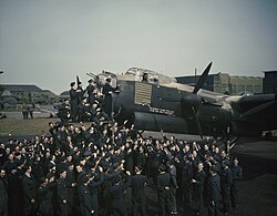 The aircrew and ground staff of No. 467 Squadron at RAF Waddington, England, celebrate Avro Lancaster R5868 "S for Sugar" completing 100 operations, May 1944