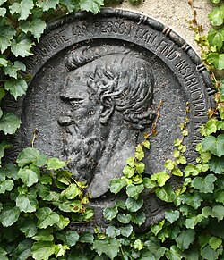 The ivy-covered emblem of Ezra Cornell and university motto