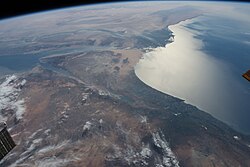 NASA photo showing depth of the Dead Sea basin (slightly below center). The Mediterranean Sea is on the right, with the Suez Canal visible connecting it to the Red Sea on left (slightly above center).
