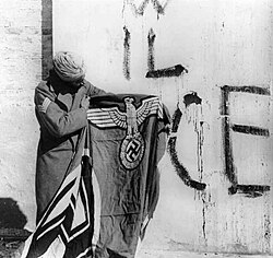 Sikh soldier with captured Nazi Swastika flag