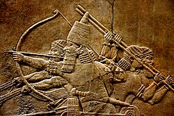 Relief depicting Ashurbanipal in a chariot, armed with a bow