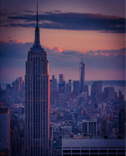The Empire State Building in the foreground, looking south from the top of Rockefeller Center with One World Trade Center in the background