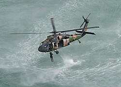 A 1st Commando Regiment soldier jumping from a 16th Aviation Brigade, 171st Special Operations Aviation Squadron Black Hawk helicopter