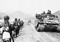 British UN troops advance alongside a Centurion tank, March 1951