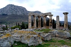 The Temple of Apollo at Corinth, built c. 540 BC, with the Acrocorinth (i.e. the acropolis of Corinth that once held a Macedonian garrison)[159] seen in the background