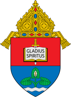 Coat of arms of the Archdiocese of Nueva Segovia depicting a flowering bíga (Alocasia macrorrhizos)