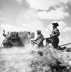 Gurkhas in action with a six-pounder anti-tank gun in Tunisia, 16 March 1943