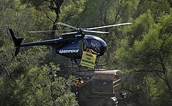A bulldozer clearing native forest in the Chaco Boreal and environmentalists campaigning against it