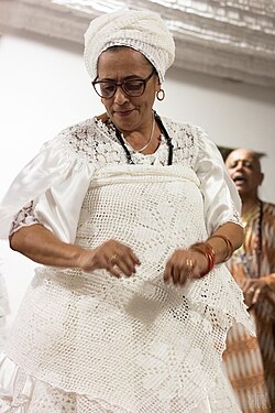 An Umbandista wearing the white clothing typically worn in the religion's ceremonies