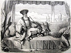 Boyar Iordache Filipescu, dressed in the Phanariote boyar fashion, sitting on a divan