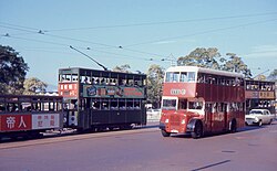 A double-decker bus and two double-decker trams in Queen's Road Central, 1967