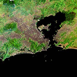 Satellite image of the metropolitan area, with the capital from the center below, Baixada Fluminense on the north-west and Niterói and São Gonçalo east of the Guanabara Bay