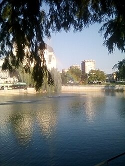 A park in Podgoria, Arad, featuring in the background Holy Trinity Cathedral and other buildings.