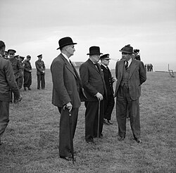 Lindemann, Churchill, Vice Admiral Phillips, and Alwyn Crow watching a demonstration at Holt, Norfolk