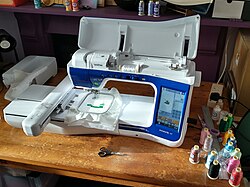 Brother Innov-is V7 computerised Sewing/Quilting/Embroidery machine embroidering onto cloth held in a hoop