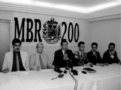 A 1997 image of MBR-200 members meeting (Nicolás Maduro is seen on the far left while Chávez is seen speaking in the center)
