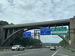 Sign welcoming drivers to the New Jersey Turnpike under the Edgewood Road Bridge