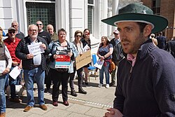 Juan Corlett speaking at a protest about ME