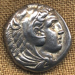 Obverse of the tetradrachm of Alexander the Great, intended to be seen as a deity, wearing the attributes of the hero Heracles. Struck in 325 BC.