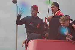 Thiago celebrating winning the cup double in a trophy parade with Liverpool in 2022.