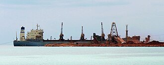 Bauxite being loaded at Cabo Rojo, Dominican Republic, to be shipped elsewhere for processing; 2007