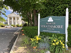 An entrance to North Strathmore, with the Onderdonk House in the background