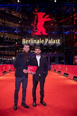 Basel Adra and Yuval Abraham holding their Berlinale Documentary Award
