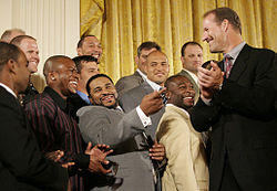 Members of the Pittsburgh Steelers visit the White House following their Super Bowl XL victory, with Jerome Bettis at center pointing toward head coach Bill Cowher.