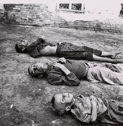 Two men and a child, all dead from starvation during the Russian famine of 1921–1922