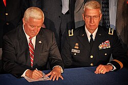 Corbett signing bills into law designed to benefit PA veterans, alongside Major General Wesley Craig.
