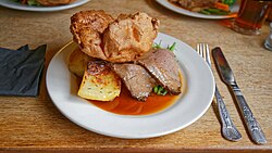 A Sunday roast served on a bed of gravy