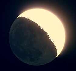 Earthshine reflected from the Moon, as seen through a telescope. The bright region is directly illuminated by the Sun, while the rest of the Moon is illuminated by sunlight reflected from Earth.