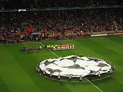 The two teams line up for the UEFA Champions League Anthem before each match and a flag of the Champions League "starball" logo is waved in the centre circle.