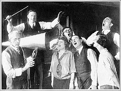 Conductor and cast members of the D'Oyly Carte Opera Company with acoustic recording horn at His Master's Voice, c. 1924