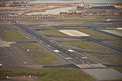 Runway 11/29 at the airport with Foreign Trade Zone No. 49 (in background) in February 2016