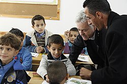 British politician Alan Duncan talking to schoolchildren at a school supported by UNRWA and UKaid in Gaza, 10 December 2012