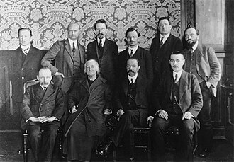 Members of the Reichstag faction of the KPD c. 1921. Sitting from left to right: Joseph Herzfeld, Clara Zetkin, Emil Eichhorn, Georg Berthelé. Standing from left to right: Max Heydemann, Walter Stoecker, Wilhelm Koenen, Wilhelm Bartz, Heinrich Malzahn, Paul Frölich.