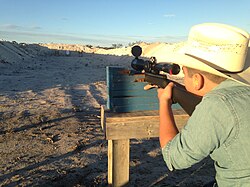 A man target practicing for the hunting season