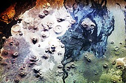 Harrat Khaybar seen from the International Space Station. Saudi Arabia is home to more than 2000 dormant volcanoes.[135] Lava fields in Hejaz, known locally by their Arabic name of harrat (the singular is harrah), form one of Earth's largest alkali basalt regions, covering some 180,000 square kilometres (69,000 sq mi).[136]