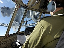 Using a probe-and-drogue, a Royal Air Force C-130K Hercules crew practice refueling from an RAF VC10 tanker over the Falkland Islands, 2005