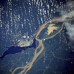 Manaus, the largest city in Amazonas, as seen from a NASA satellite image, surrounded by the dark Rio Negro and the muddy Amazon River